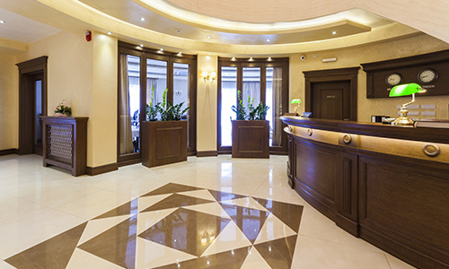 commercial reception area with elegant wood reception desk and mouldings